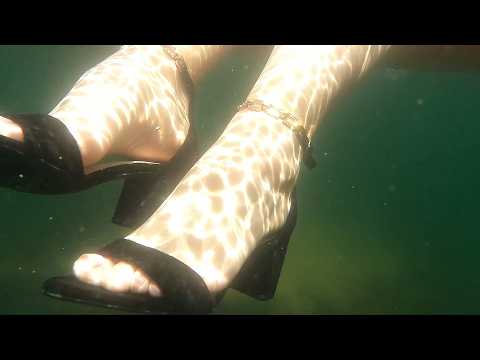 Girl puts her feet in high heels underwater asmr