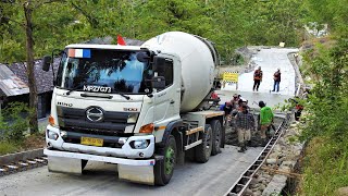 Ready Mix Cement Trucks Pouring Concrete On The Step Road Paving Construction