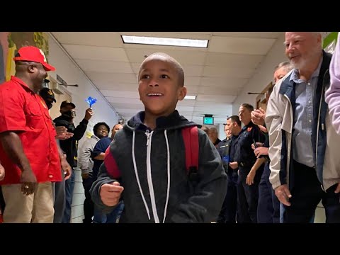 Dozens of men surprise west Louisville elementary schoolers, promoting positive male role models