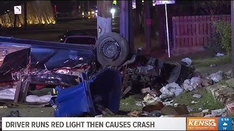 Driver accused of running red light, causing rollover crash