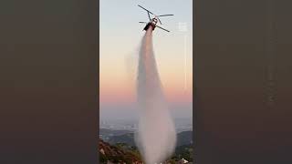 Watch This Helicopter Drop Water to Help Extinguish Fires