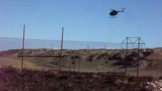 Famous Helicopter stringing cable on Hughes Transmission Project Profile