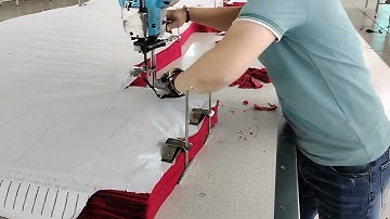 Khi quản đốc nhà cắt thể hiện cắt vải bằng máy cắt cầm tay