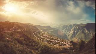 dramatic aerial mountain village view colorful cloudy sunset sky motion explore beauty w