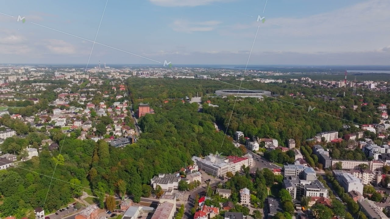 Aerial view of Kaunas, Lithuania on a sunny summer day. The camera pans across the cityscape