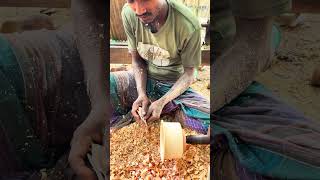The boy is making an eco-friendly cooking pot from a piece of wood.