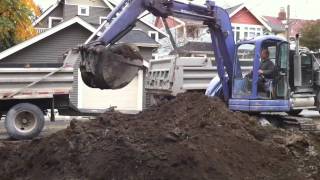 loading trucks with komatsu PC75 excavator