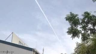 Persistent contrails, making clouds from aircraft.