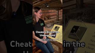 Aly discusses the cheaters dice on display in the underground of Old Sacramento
