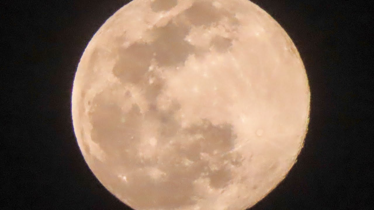 Pink Super moon Jaipur India in clouds 7 April 2020.