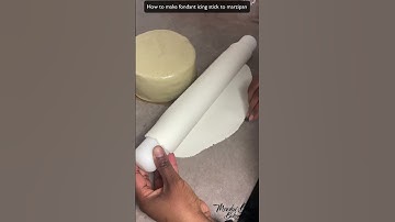 How to make fondant icing stick to marzipan : Covering a fruit cake with marzipan and fondant