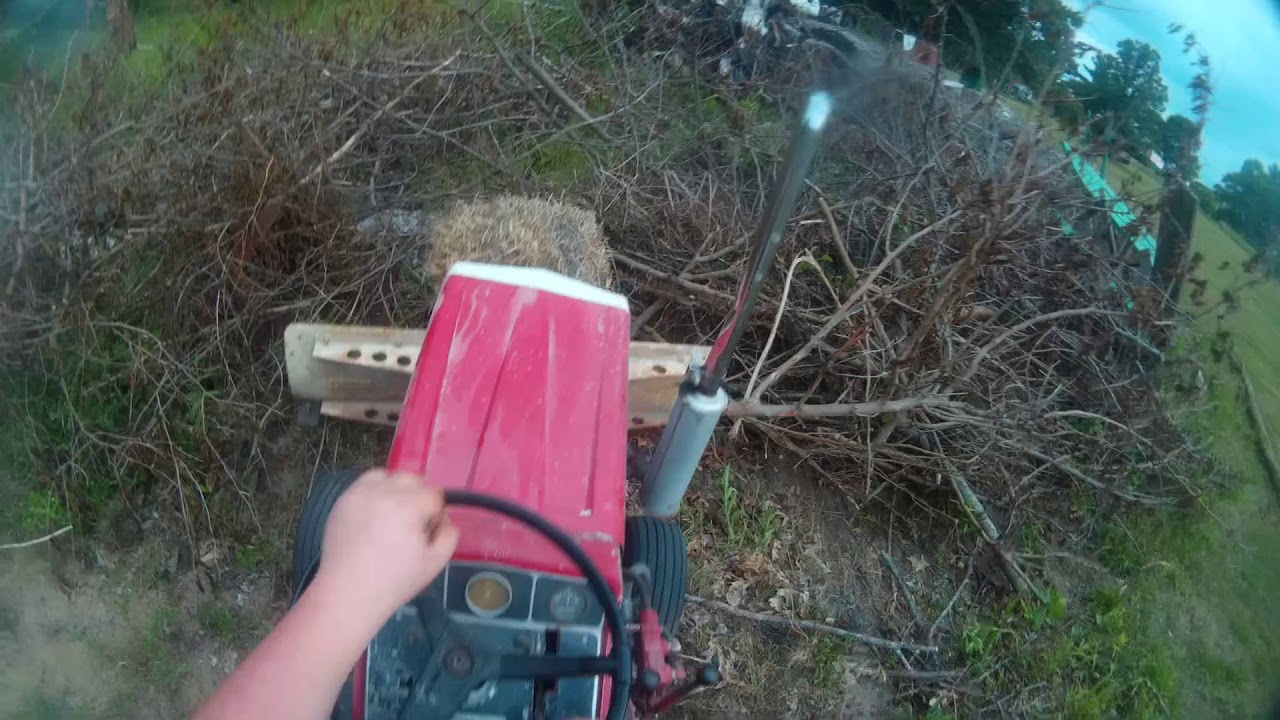 Cub Cadet 1450 Pulling Logs and Cleaning Up Brush Pile YouTube