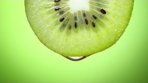 Close Up or Macro of a Slice of Kiwi, a Drop of Water Falls in Slow Motion. | Stock Footage -