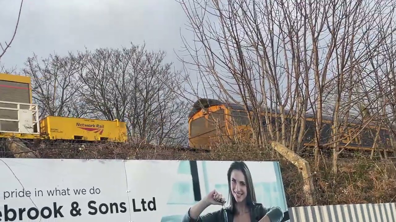 GBRF class 66s head rail  treatment train passing through heading to  towards Christchurch 