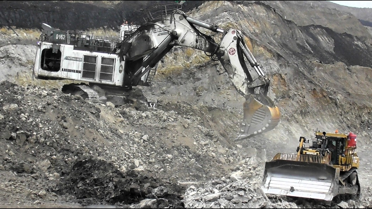 Liebherr R9350 Excavator Teaming Up with Caterpillar D9T Dozer at the Overburden Loading Area