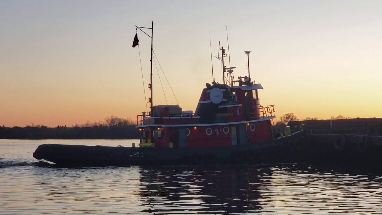 Tugboat John R Asher taking a Barge away at sunset