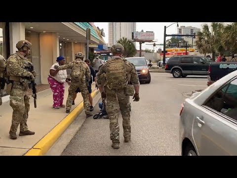 Police officers detain pair of Myrtle Beach protesters (explicit)