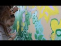 Children from SmartKids Learning Center paint mural