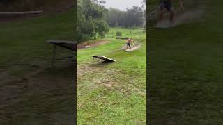 Guy surfs down wet grass hill on boogie board and crashes into folding table set up as a ramp