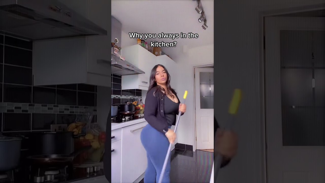Dancing with a mop in the kitchen