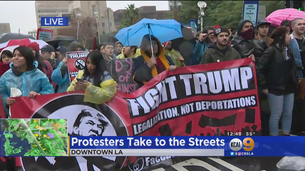 Trump Protesters Brave Heavy Rain In Downtown LA