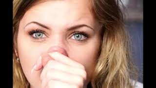 Close-up of a blonde woman blowing her nose