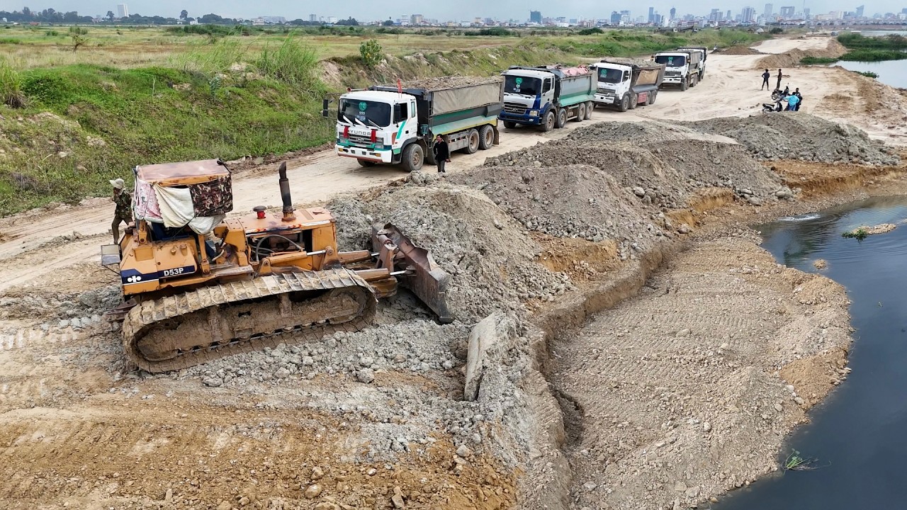 Massive Heavy Equipment Work- Bulldozer Pushes Soil Mixed Stone Ft Dump Truck Unloading