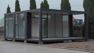 Container hotel with glass wall and cladding panel