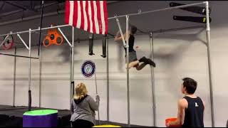 Boy doing American Ninja Warrior competition bumps head when swinging on pole