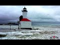 Relaxing ice waves rolling over michigan city lighthouse