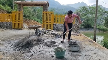 Girl builds a retaining wall with stone and red bricks / Ly Nhe