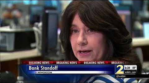Man accused of holding hostages at bank calls WSB-TV