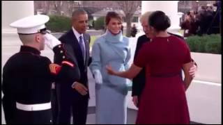 Melania Trump gives a gift to Michelle Obama as the Obamas welcome the Trumps to the White House