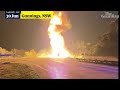 Trucks carrying alcohol and butane cans burst into flames after crash on Australian highway
