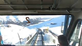 Riding the St. Moritz funicular down from the top.