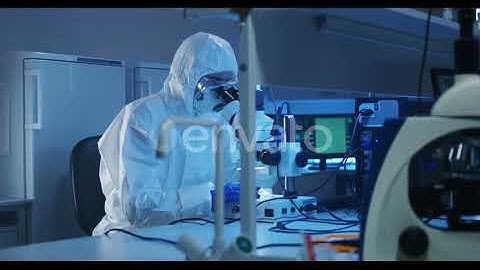 Scientist Examining Sample with a Microscope | Stock Footage - Envato elements