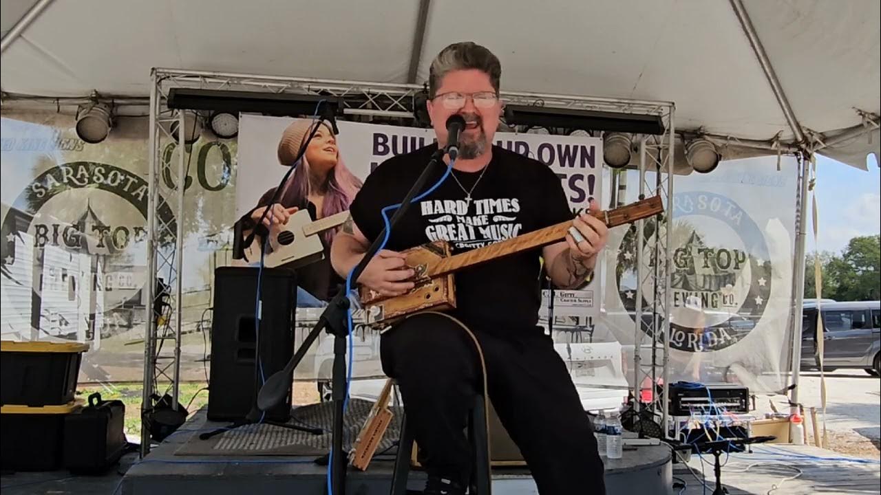 Shane Speal Playing A Mainely Cigar Box Guitar At The 2025 Sarasota