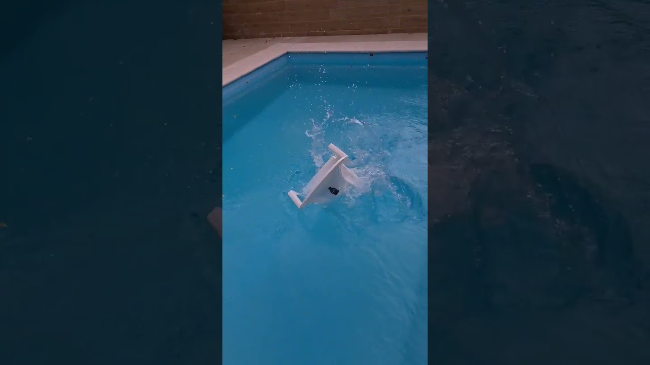 throwing a plastic chair in the pool. To break the 