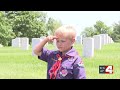 Scouts place flags on graves at Jefferson Barracks
