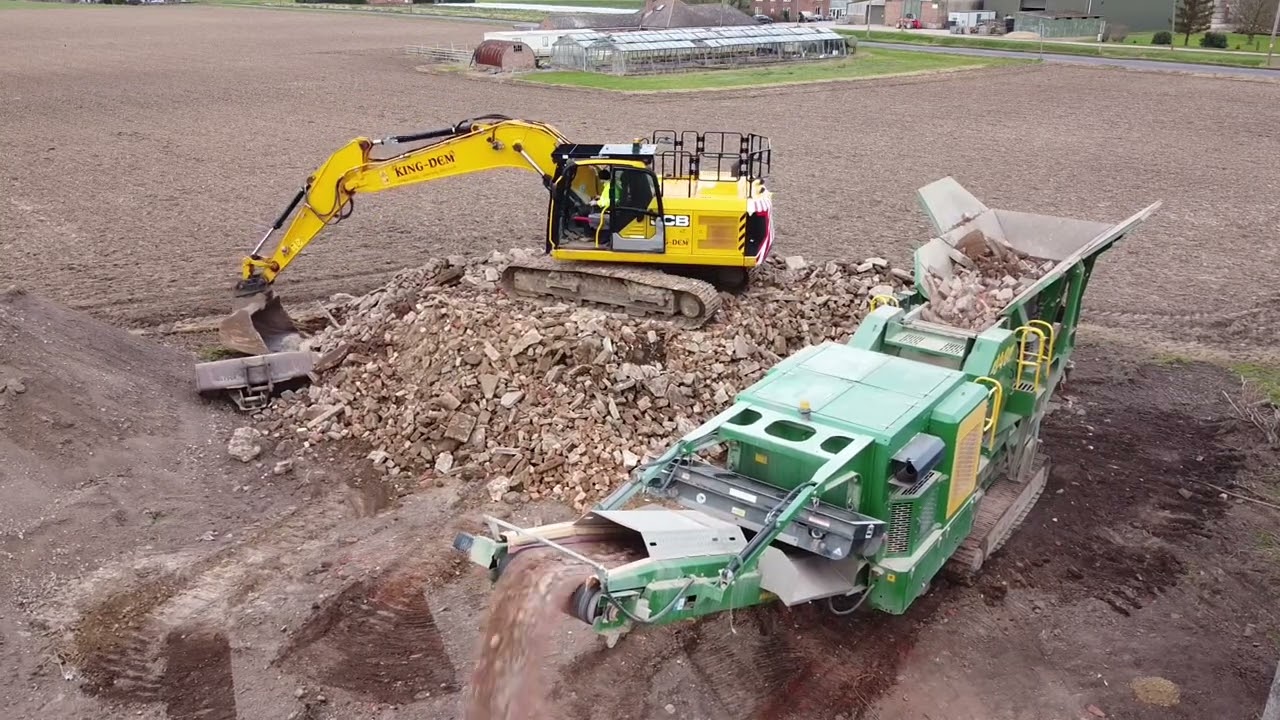 MCcloskey J40 Jaw Crusher loaded by JCB 220X Excavator (Ariel footage)
