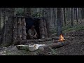 Build a small survivor cabin with large split beams.primitive technology.Cooking chicken on a stick.