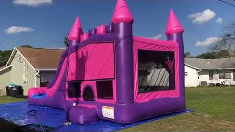 Deflate and roll up the pink waterslide bounce house combo