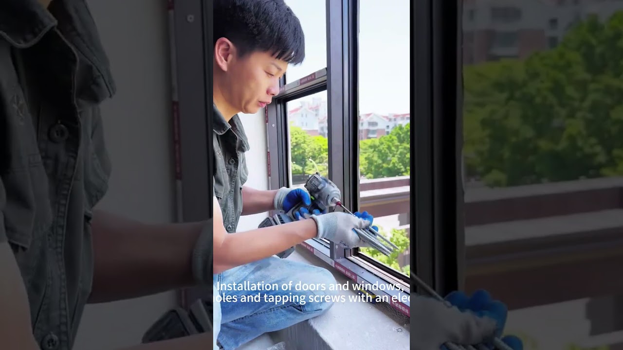 Workers are installing floor to ceiling windows and fixing them with screws