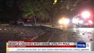 Vehicle crashes into home, utility pole in Mobile