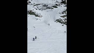 Skier rides downhill then flips forward and tumbles down the mountain