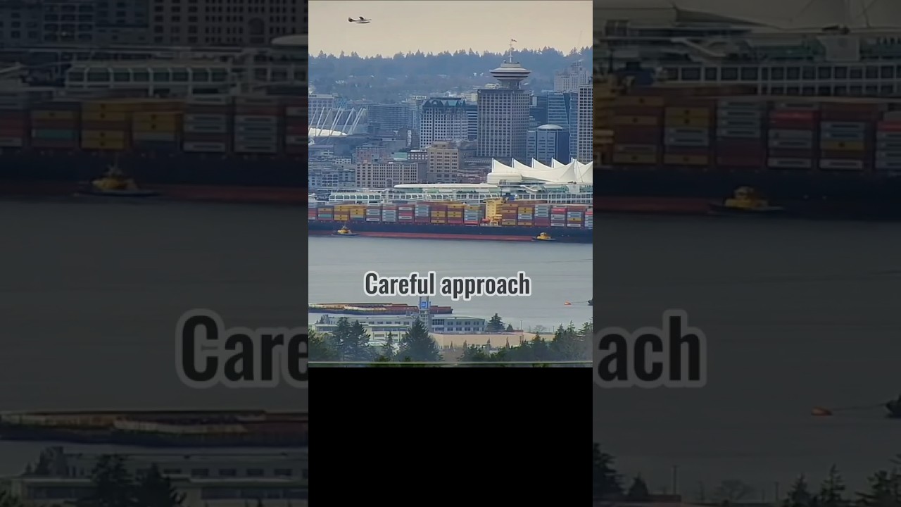 Large container ship navigates a crowded Vancouver harbour