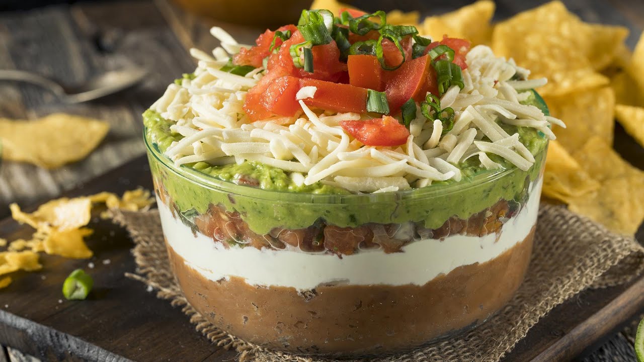 How To Make Seven-Layer Dip With Spiced Sour Cream + Green Chiles By David Burtka | Rachael Ray Show