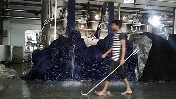 Fabric unloading from dyeing machine .