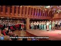 Chinese and american high school students perform auld lang syne