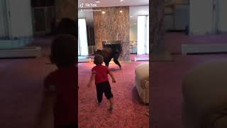 Woman does TikTok dance then her little boy jumps over her and she's on the ground and flips forward